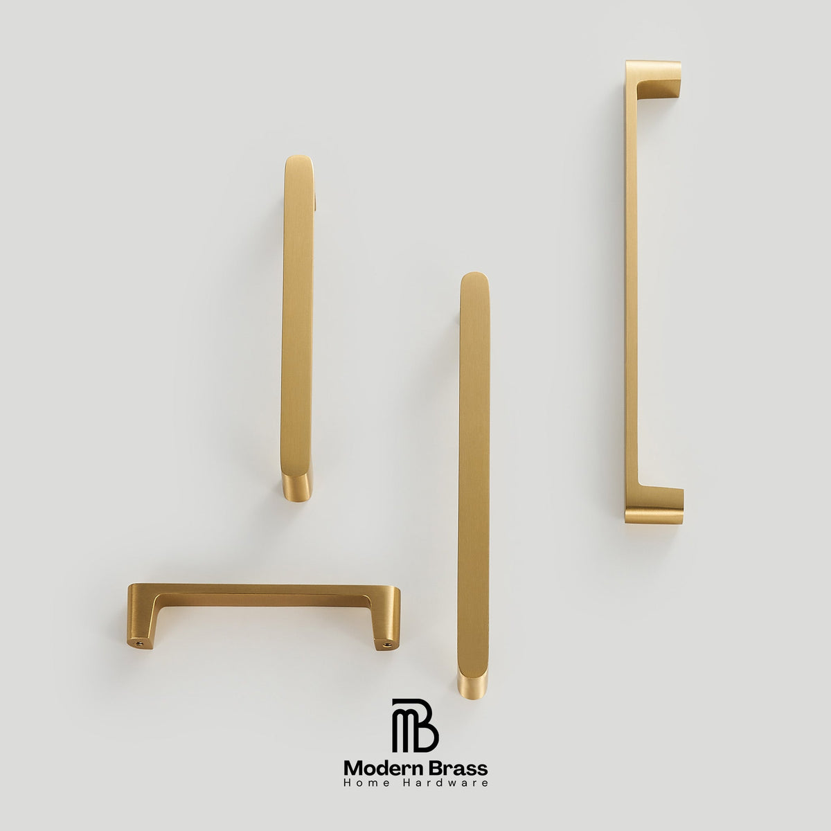 Four matte brass home hardware handles in different shapes, arranged on a light gray background with the Modern Brass logo at the bottom.