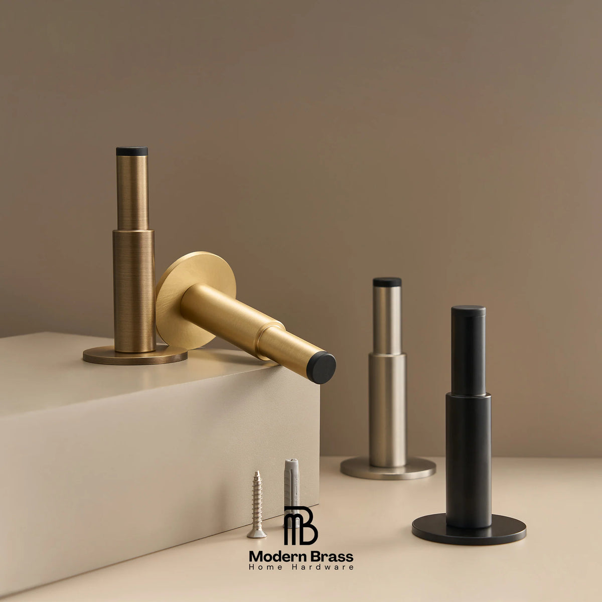 Modern brass hardware set including a round wall plate, mounting bracket, and cylindrical posts in brushed gold, satin silver, and matte black finishes, shown with screws on a beige background. The Modern Brass logo is visible at the bottom.