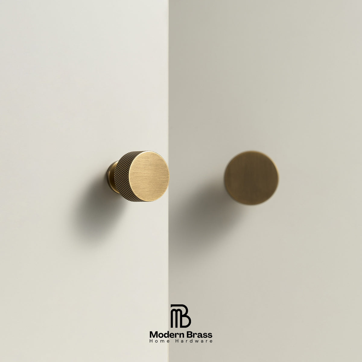 Two round cabinet knobs in a brushed brass finish, one with a knurled side and one smooth, mounted on a light beige wall or door. The Modern Brass Home Hardware logo is visible at the bottom.