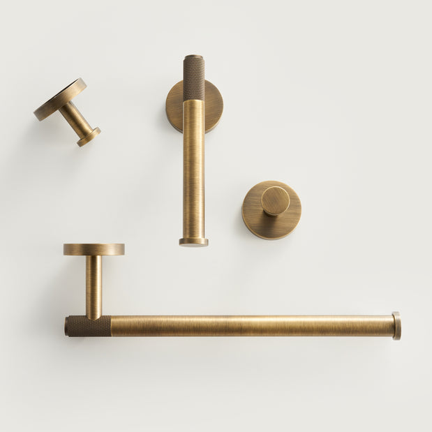 Set of brass door handles and fixtures on a white background