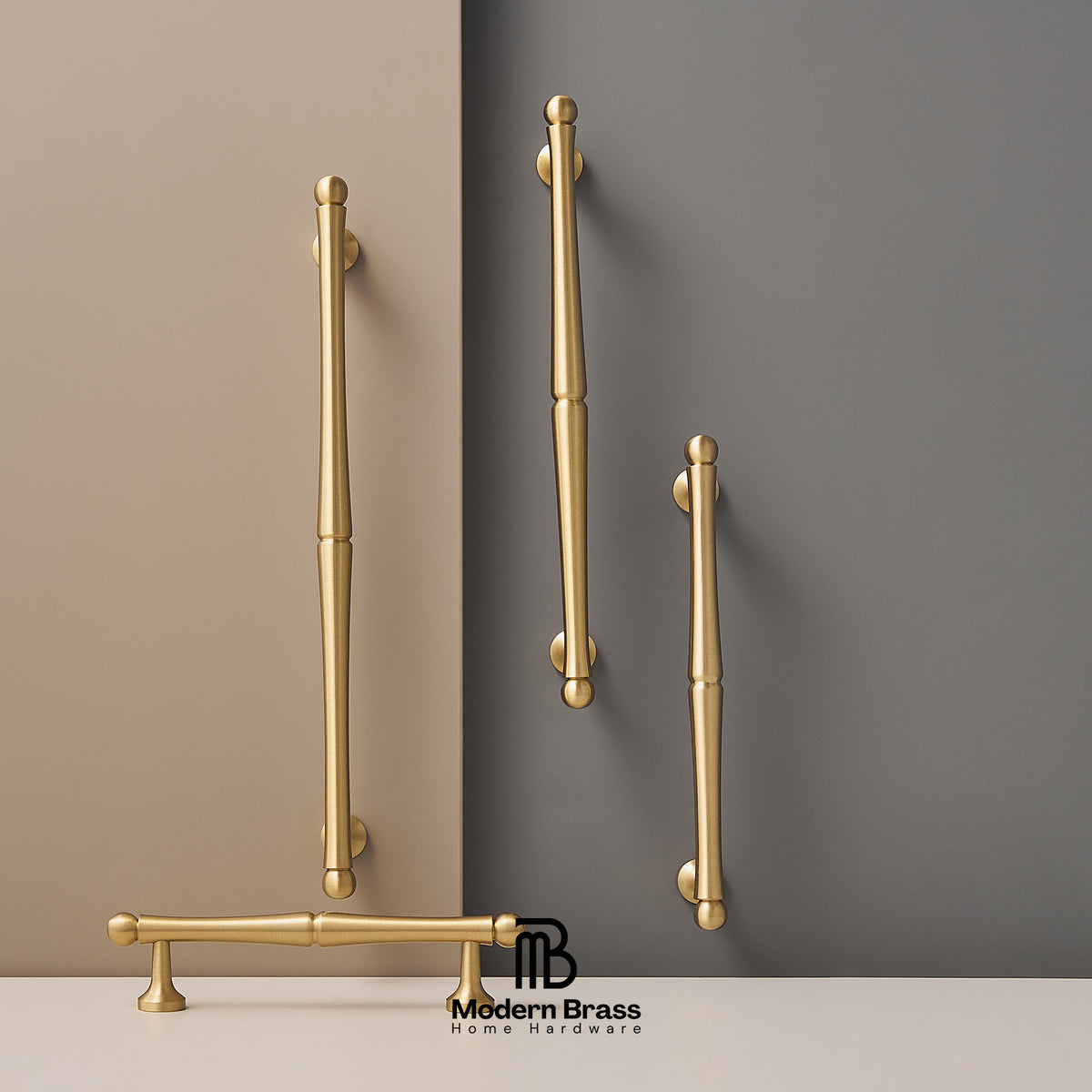 Gold handles on a wall with 'Modern Brass' branding.