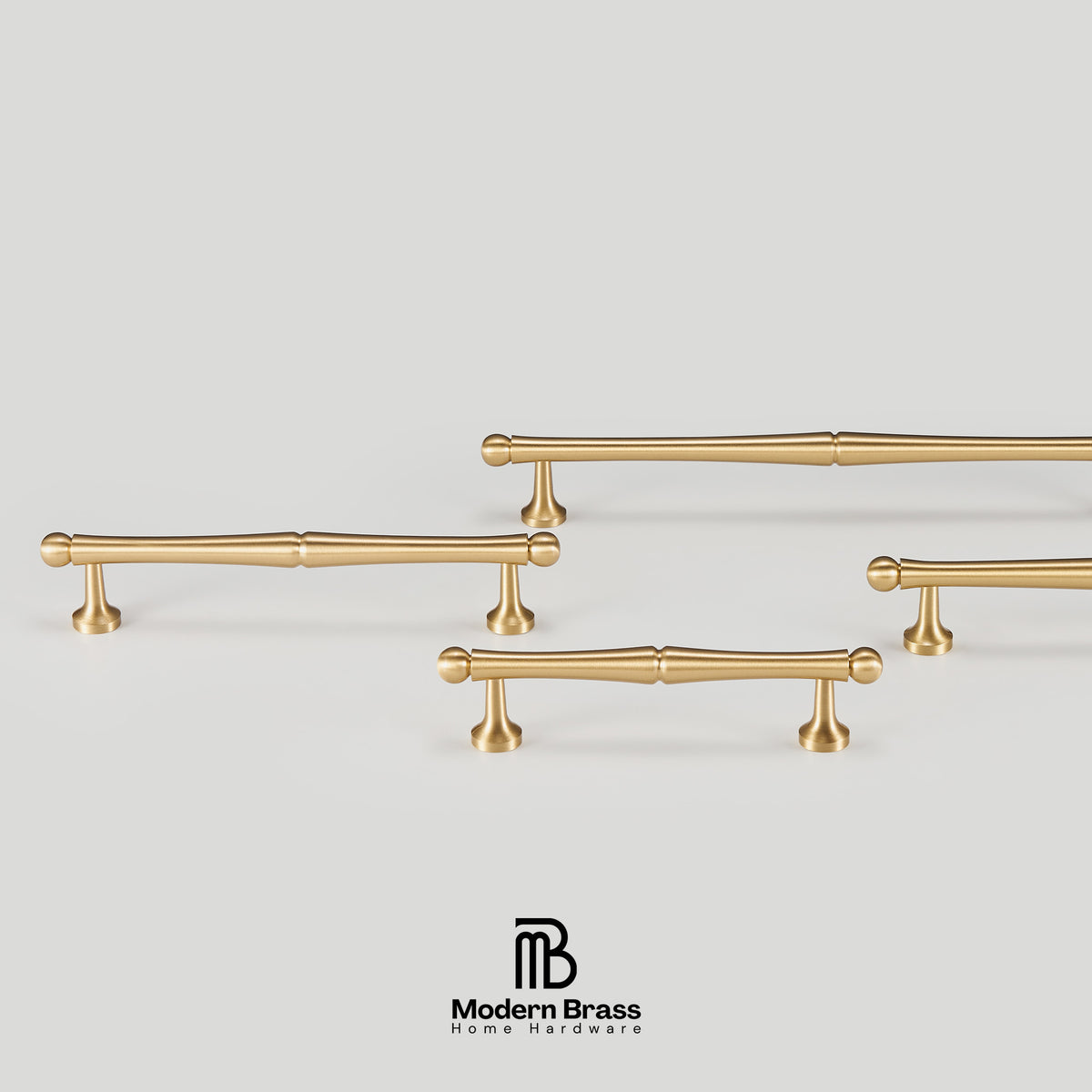 Set of gold cabinet handles on a light gray background with 'Modern Brass' branding.