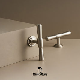 Metallic door handles on a beige surface with 'Modern Brass' branding.