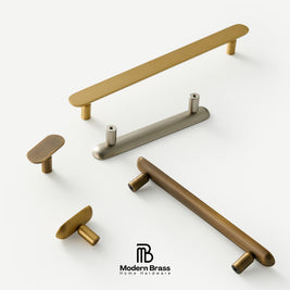 Five modern brass and bronze cabinet hardware pieces, including two long bar pulls, two oval knobs, and two round knobs, displayed on a clean white background with the Modern Brass logo at the bottom.