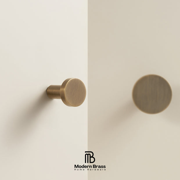 Brass door handle on a white door with 'Modern Brass' logo.