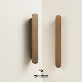 Two wooden door handles on a beige background with 'Modern Brass' branding.