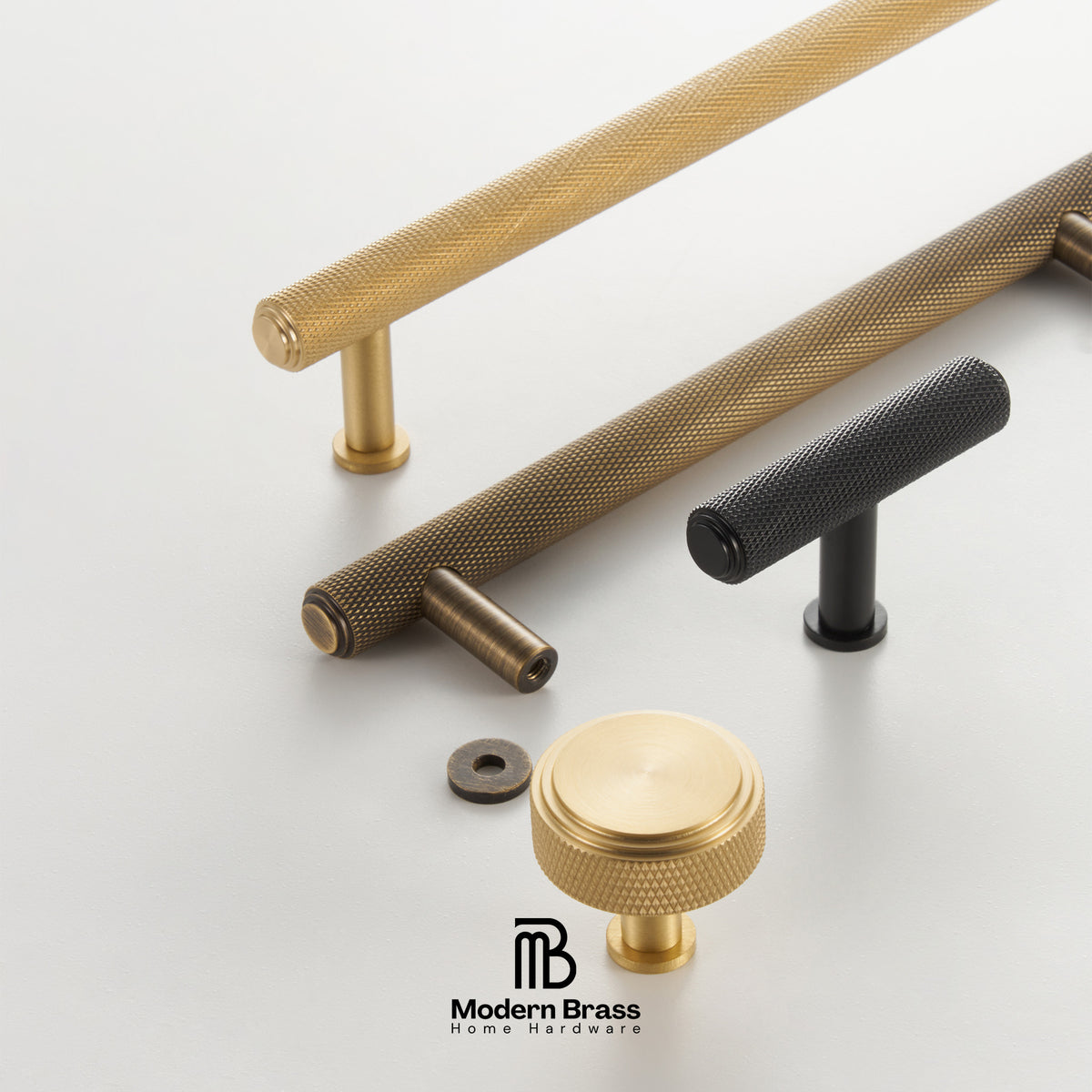 Modern brass and black metal drawer hardware set on a light gray background, featuring textured bar handles and a round knob with a visible Modern Brass logo at the bottom.