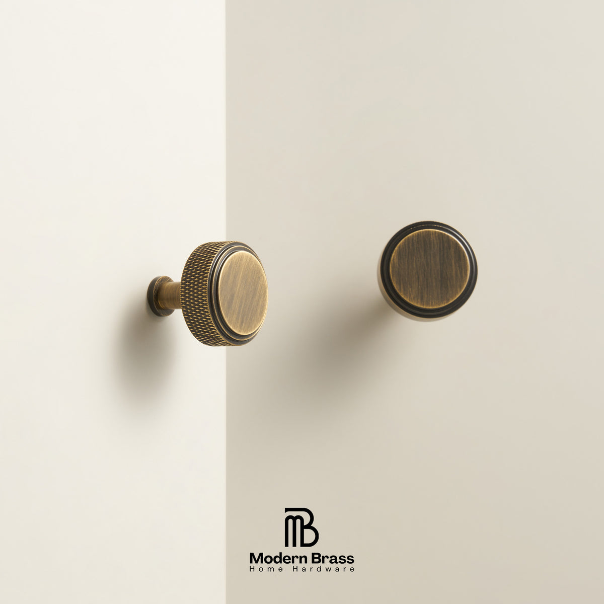 Two brass cabinet knobs in an antique finish shown on a clean, off-white background, with the Modern Brass logo at the bottom.