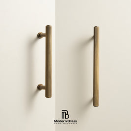 A set of antique brass cabinet hardware, including round knobs and straight pull handles, arranged diagonally on a clean white background with the Modern Brass Hardware logo at the bottom.