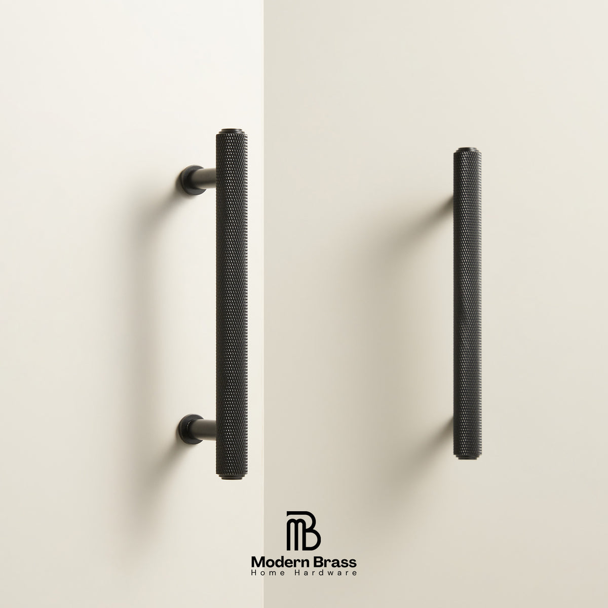 Two modern vertical cabinet handles in a textured matte black finish, mounted on a clean off-white wall. The Modern Brass Home Hardware logo is visible at the bottom center.