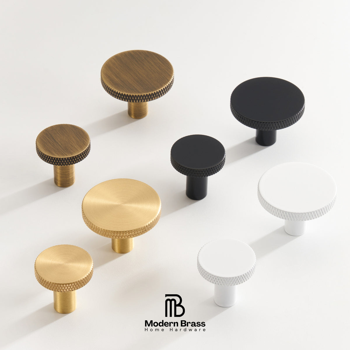 A set of modern cabinet knobs in brushed brass, black, and white, arranged on a clean white background with the Modern Brass Home Hardware logo at the bottom.