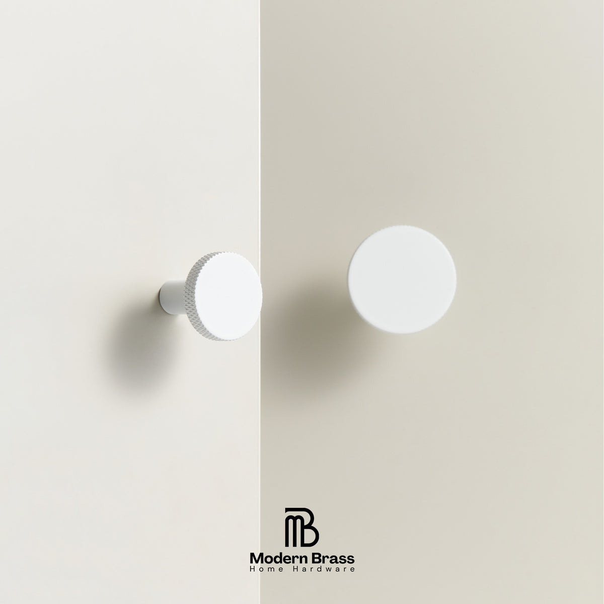 Two white round cabinet knobs mounted on a light beige wall, with one knocker featuring a textured outer ring and the other a smooth matte finish. The Modern Brass Home Hardware logo is visible at the bottom.