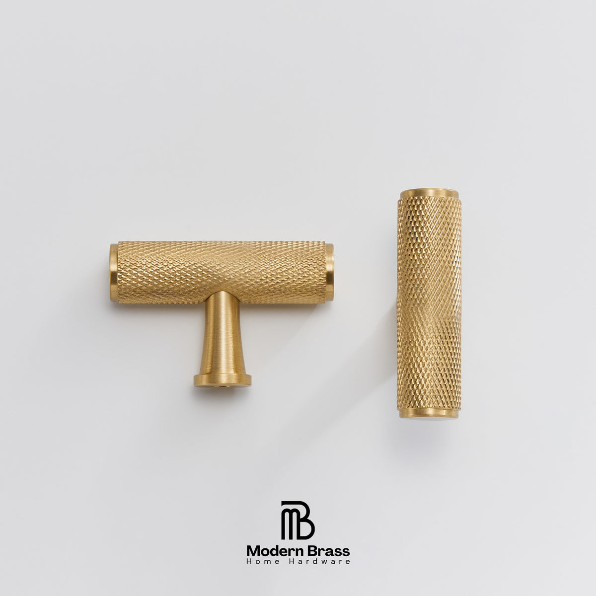 Two brass cabinet knobs with textured knurled surfaces, one T-shaped and one cylindrical, displayed on a light gray background with the Modern Brass logo at the bottom.