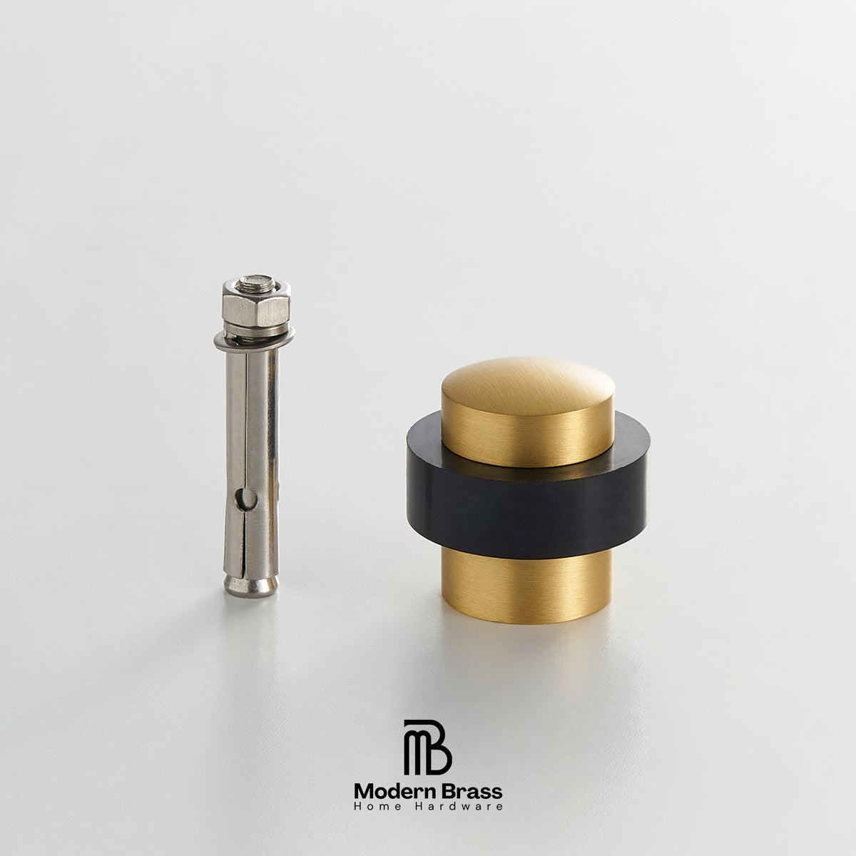 Three round cabinet knobs in black, matte brass, and brushed brass are arranged on a light beige surface against a warm beige background. The Modern Brass logo is visible at the bottom.