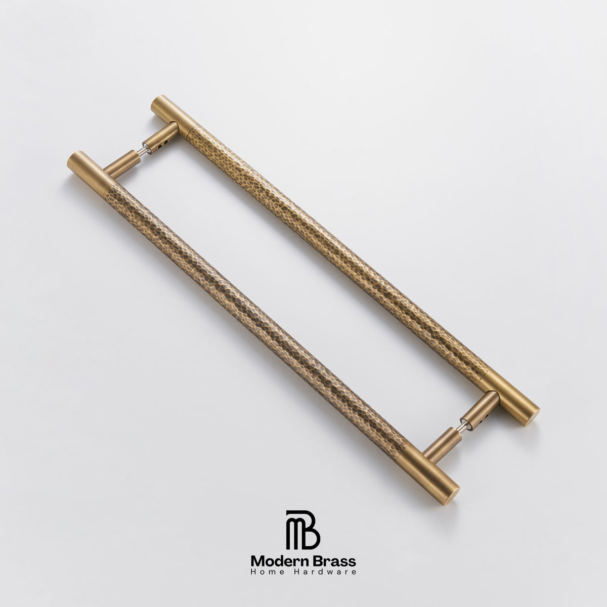 Pair of gold handles on a light gray background with 'Modern Brass' branding.