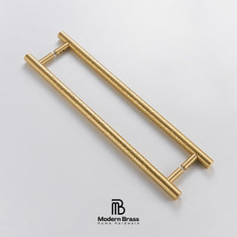 Gold door handles on a light gray background with 'Modern Brass' branding.