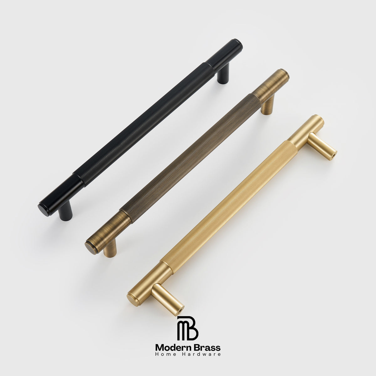Three modern cylindrical cabinet pulls shown on a light gray background: one matte black, one dark bronze, and one brushed gold. The gold pull is in the foreground, with the other two behind it at an angle.