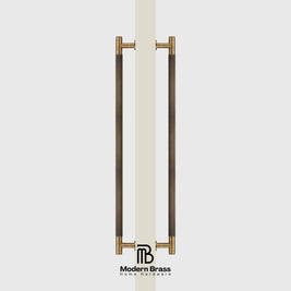 Pair of bronze door handles on a white door with 'Modern Brass' branding.