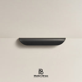 Modern industrial black crescent pull in solid brass for designer wardrobes.