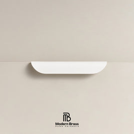 Architectural white crescent drawer handle with a smooth matte-satin finish.