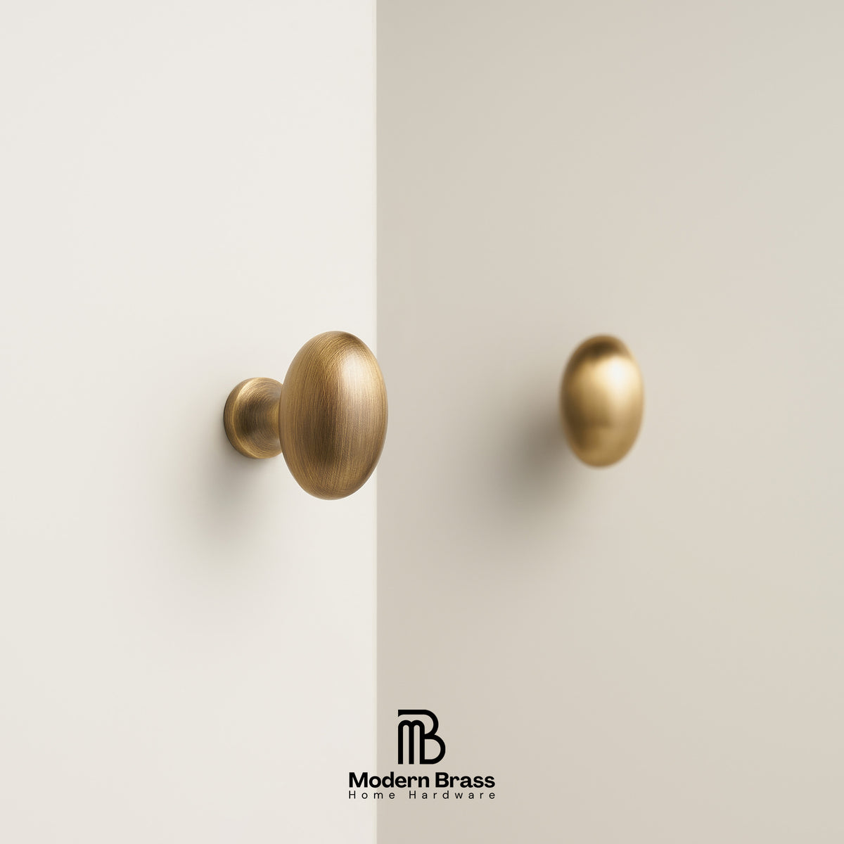 Two round brass cabinet knobs mounted on a light beige wall, with a Modern Brass logo at the bottom center.