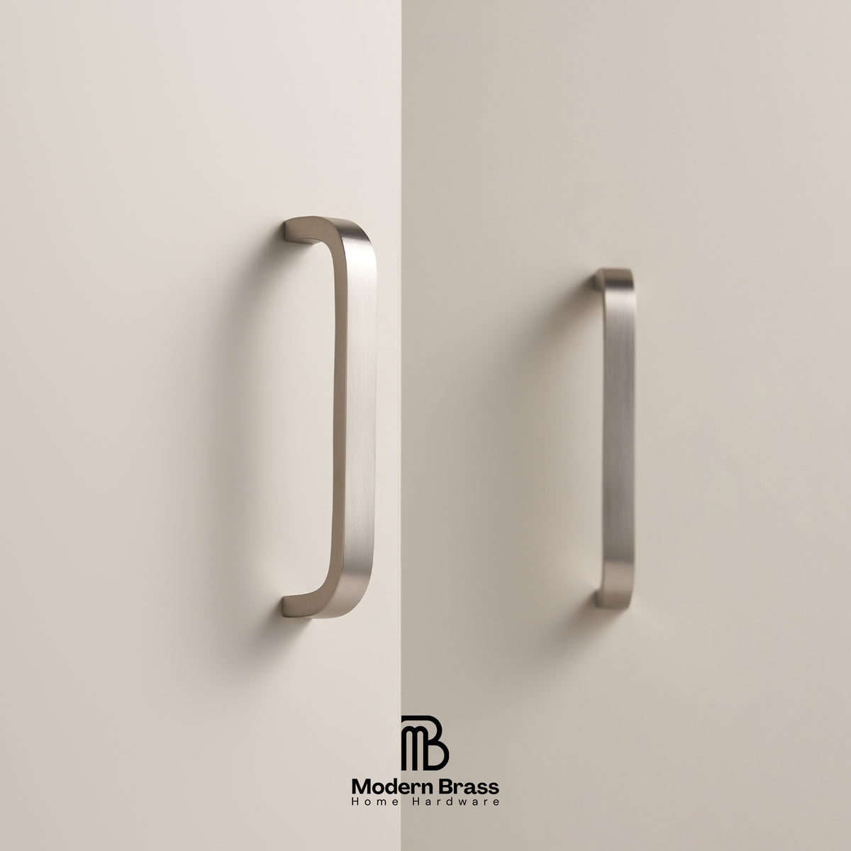 Two modern curved cabinet handles in a brushed brass finish mounted on a light beige door, with the Modern Brass Home Hardware logo at the bottom.