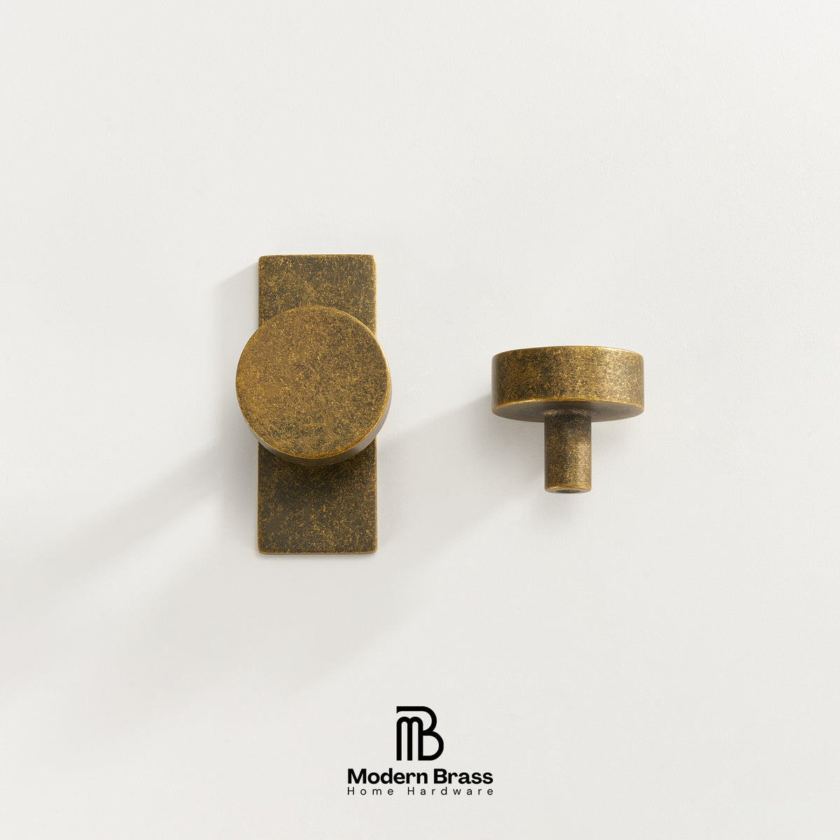 Two brass cabinet knobs, one with a round knob on a rectangular backplate and one as a single round knob, shown on a clean white background with the Modern Brass logo at the bottom.
