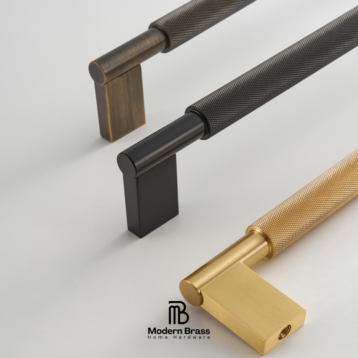 Three modern cabinet pull handles with knurled textured shafts and square block bases, shown in black, dark bronze, and gold finishes on a light gray background. The Modern Brass logo is visible at the bottom.