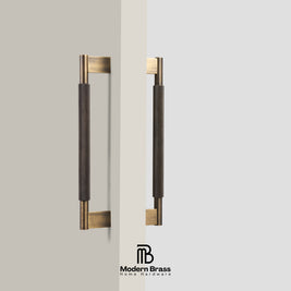 Close-up of brushed gold knurled solid brass door handle showing threaded screw mounting post base