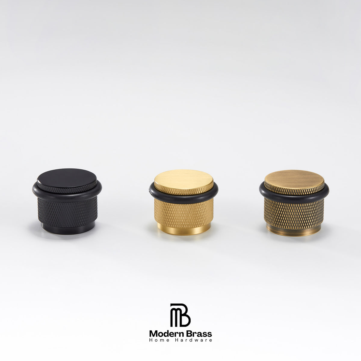 Three brass and black home barware knobs displayed on a light gray background, with the Modern Brass logo at the bottom.