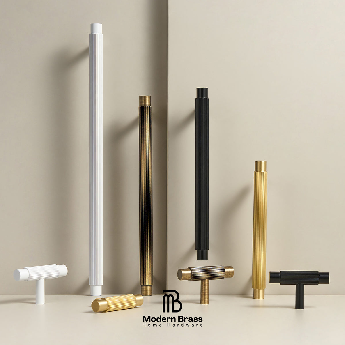 Six modern cylindrical and T-shaped hardware pulls in white, black, and brass finishes arranged on a beige surface against a beige background, with the Modern Brass Home Hardware logo at the bottom.