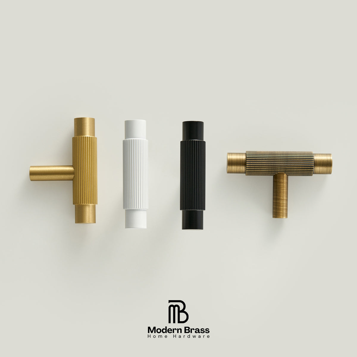 Three round cabinet knobs in black, matte brass, and brushed brass are arranged on a light beige surface against a warm beige background. The Modern Brass logo is visible at the bottom.