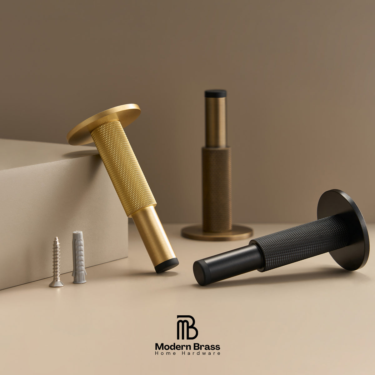 Modern brass and black metal wall anchors with matching screws, displayed on a beige surface with a beige background and the Modern Brass logo at the bottom.