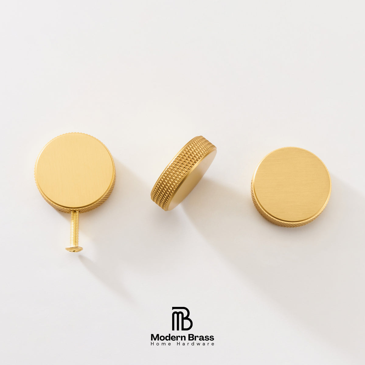 Three brass cabinet knobs in a gold finish, shown from different angles on a clean white background with the Modern Brass logo at the bottom.
