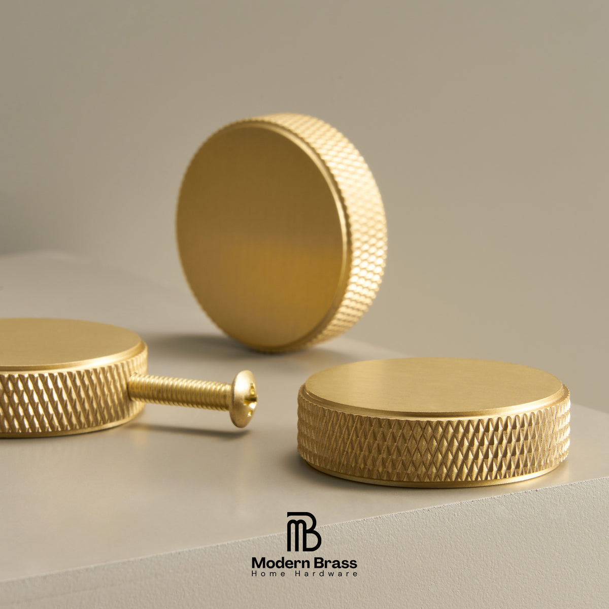 Four-piece brass cabinet hardware set including two long vertical bar handles, one short vertical bar handle, one horizontal pull handle, and three round cabinet knobs, displayed on a white surface against a beige background. The Modern Brass logo is visible at the bottom.