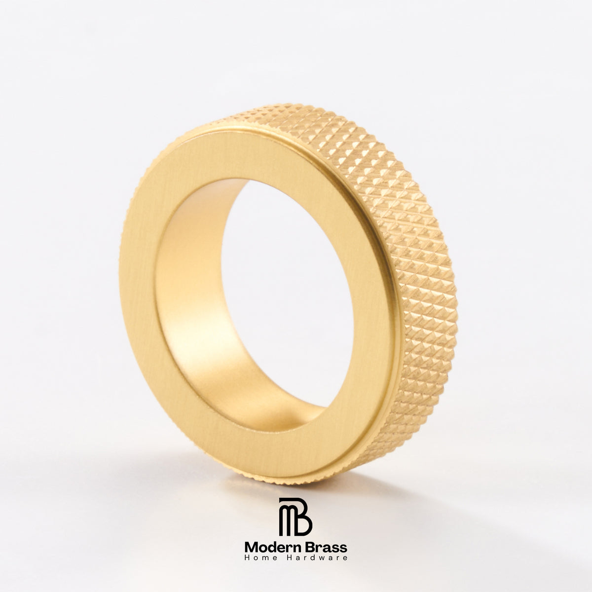 A gold-toned metal ring with a brushed matte finish on the inner band and a textured, diamond-patterned outer edge, shown on a clean white background with the Modern Brass logo at the bottom.