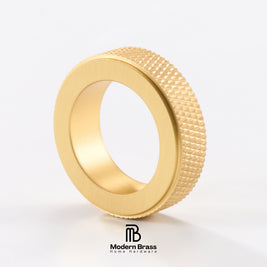 A gold-toned metal ring with a brushed matte finish on the inner band and a textured, diamond-patterned outer edge, shown on a clean white background with the Modern Brass logo at the bottom.