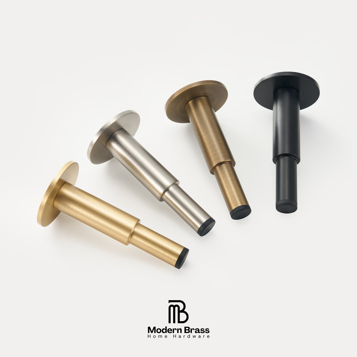 Four modern wall-mounted brass hooks in different finishes (brass, silver, bronze, and black) arranged diagonally on a light gray background, with the Modern Brass logo at the bottom.