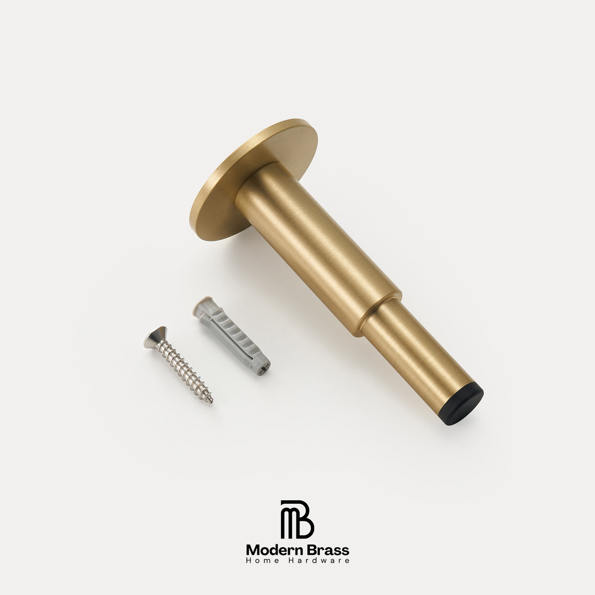 A brass wall-mounted fixture component with a round flange and cylindrical stem, shown on a light gray background with two included mounting screws. The Modern Brass logo appears at the bottom.