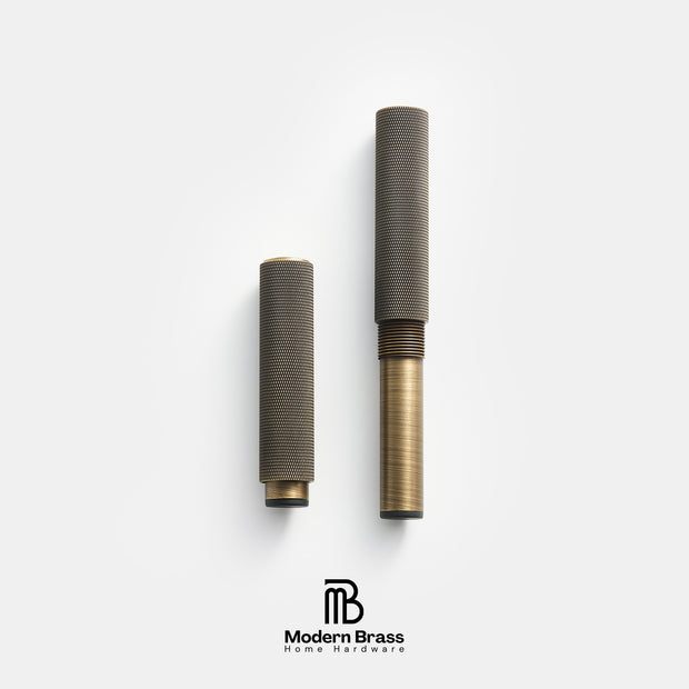 Two brass home decor accessories, likely candle holders or vases, shown in a disassembled state on a light gray background with the Modern Brass logo at the bottom.