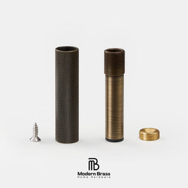 Two brass cylindrical hardware components with textured and threaded surfaces, shown disassembled with a small silver screw and gold cap on a light gray background. The Modern Brass logo is visible at the bottom.