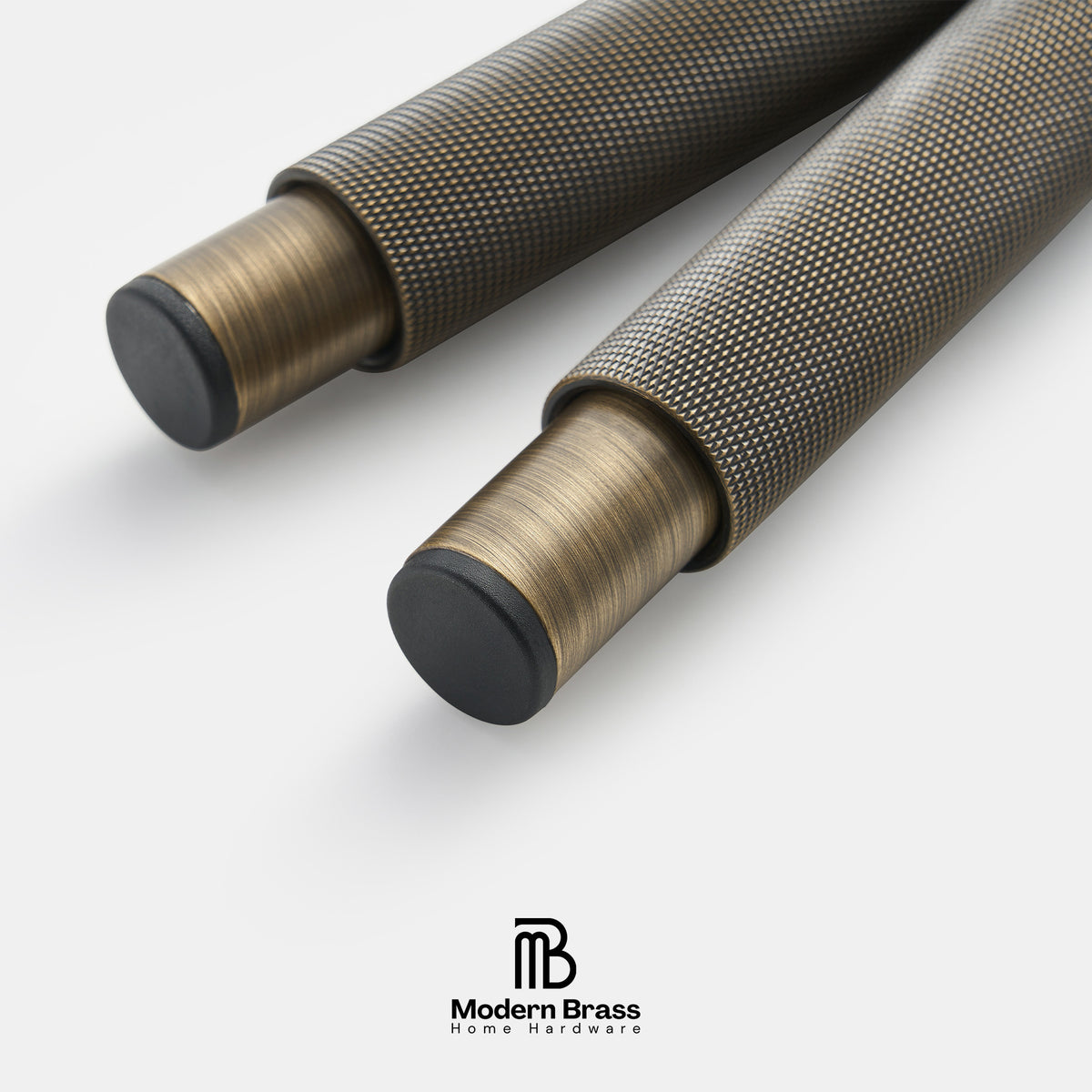 Three round cabinet knobs in black, matte brass, and brushed brass are arranged on a light beige surface against a warm beige background. The Modern Brass logo is visible at the bottom.