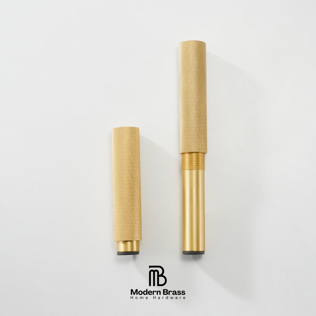 Two gold-finished brass cylindrical home instrument parts, likely mouthpieces or valve components, displayed vertically on a clean white background with the Modern Brass logo at the bottom.