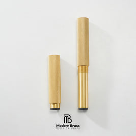 Two gold-finished brass cylindrical home instrument parts, likely mouthpieces or valve components, displayed vertically on a clean white background with the Modern Brass logo at the bottom.