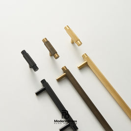Five modern cabinet pulls with textured cylindrical handles and straight bar shafts, shown in black, bronze, and gold finishes on a clean white background. The Modern Brass brand logo is visible at the bottom.