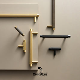 A styled product display of multiple brass and black cabinet handles arranged on a beige background, with the Modern Brass logo at the bottom.