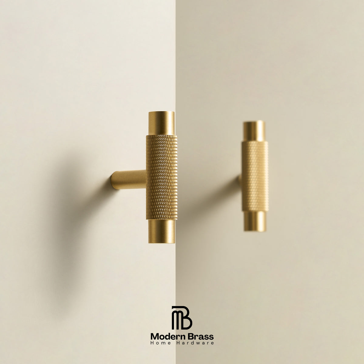 Two modern cylindrical cabinet pulls in brushed brass, one mounted on a wall and one hanging, shown against a clean off-white background with the Modern Brass logo at the bottom.