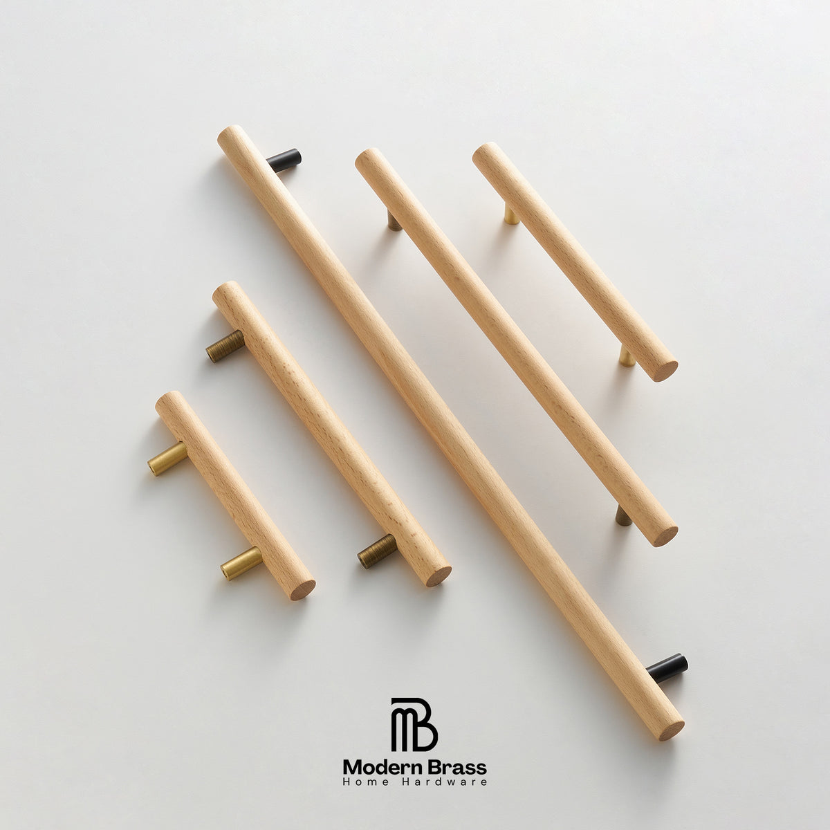 Five modern cylindrical cabinet handles made of light natural wood with brass and black metal end caps, arranged diagonally on a clean white background. The Modern Brass Home Hardware logo is visible at the bottom.